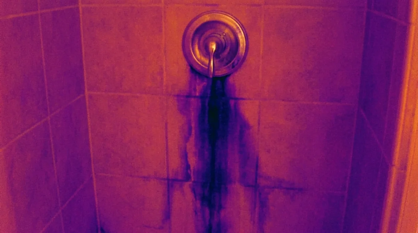 Cool streak from a hidden plumbing leak found on a Newark bathroom wall